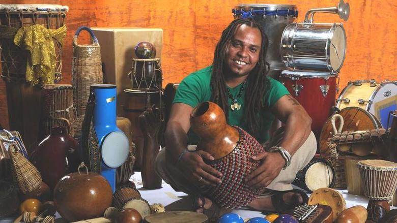 Man surrounded by percussion instruments